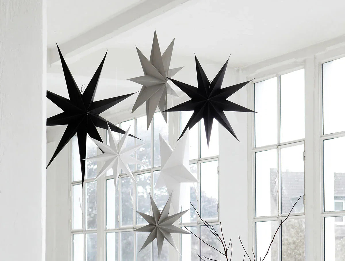 A selection of Christmas Stars hanging from a ceiling