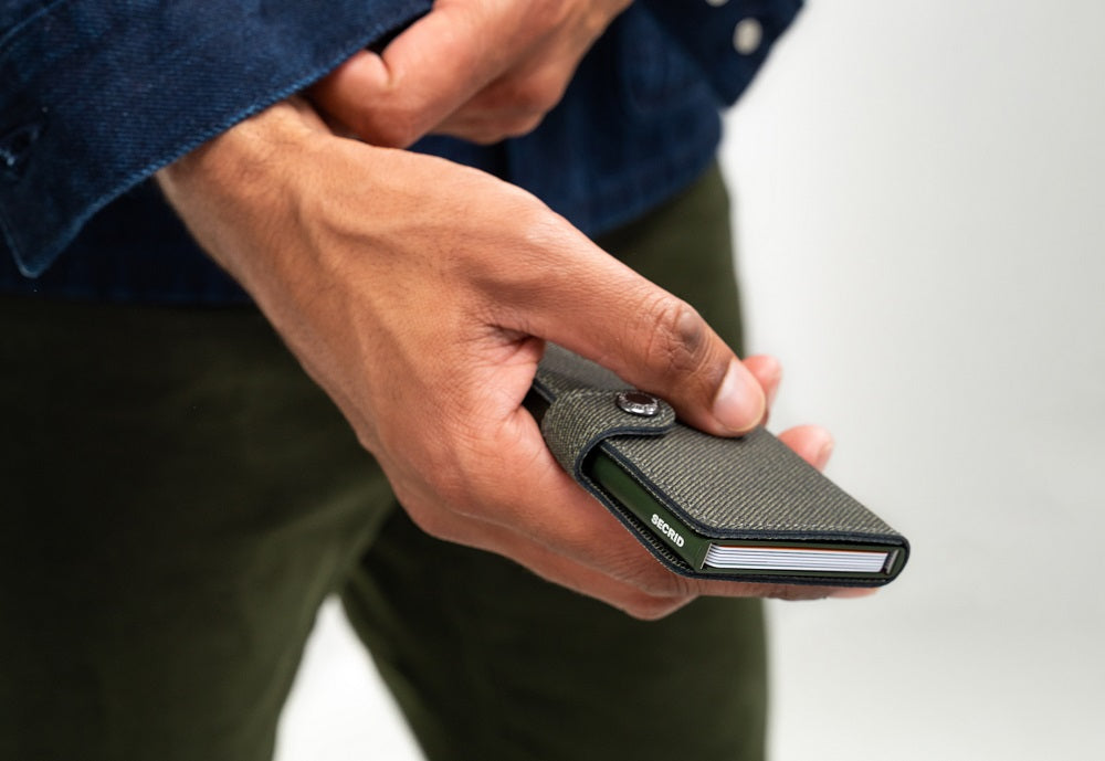 A model holding a Secrid wallet that is available at Lifestory