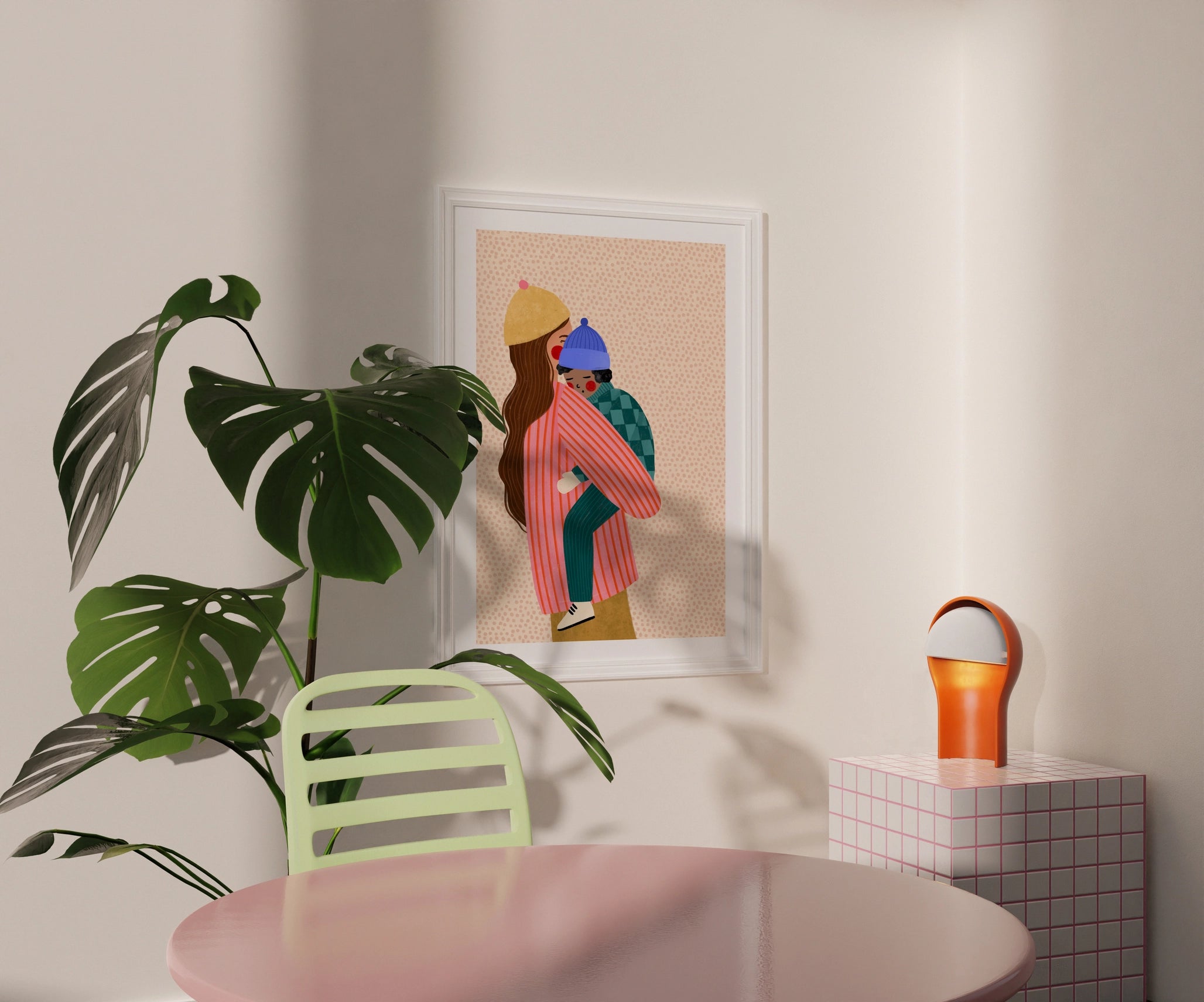 Framed artwork on a wall with a plant and table in the foreground