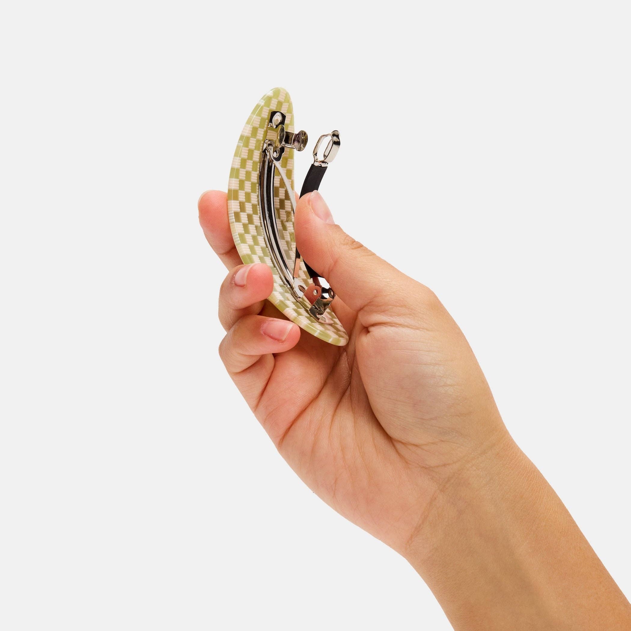 CHUNKS Oval Barrette in Olive check being held up to show the metal clasp underside