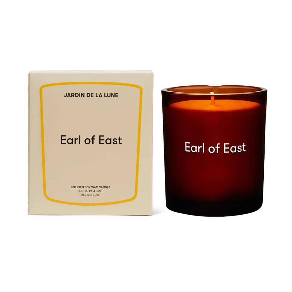 Candle labeled 'Earl of East' with packaging on a white background
