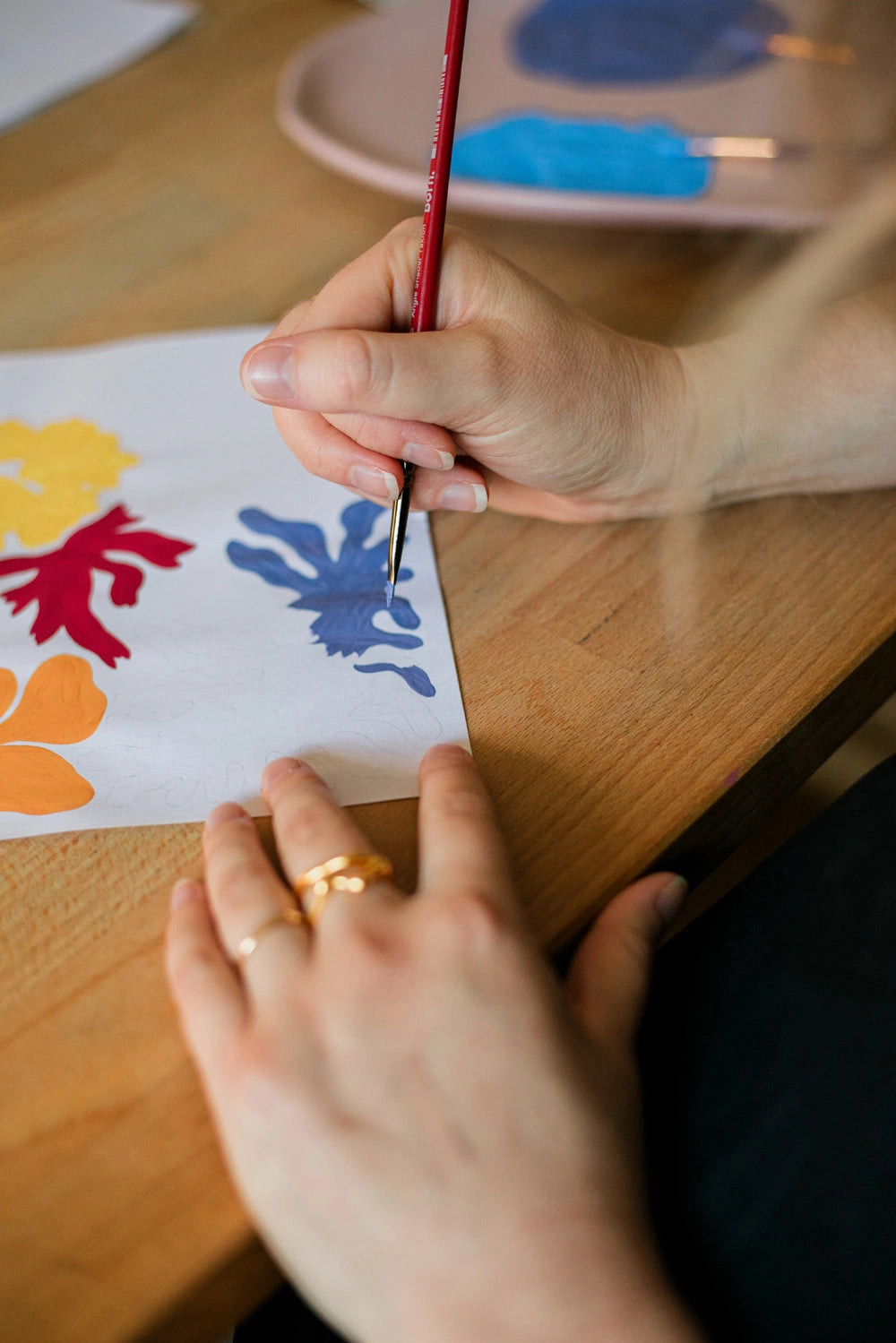 A detail shot of Liv Lees hands painting an abstract design
