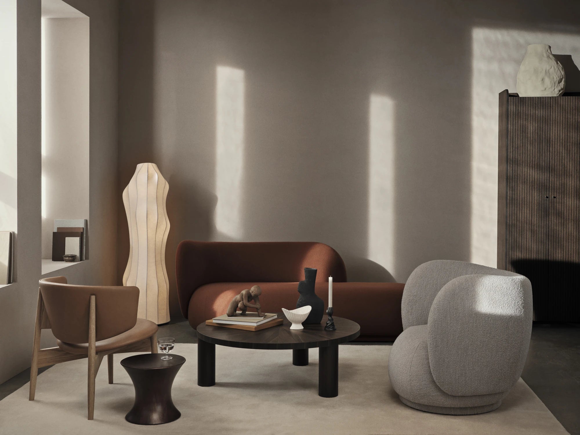 Ferm Living Rico Divan in Dark Brown next to Rico Lounge chair, Herman lounge chair and Post coffee table
