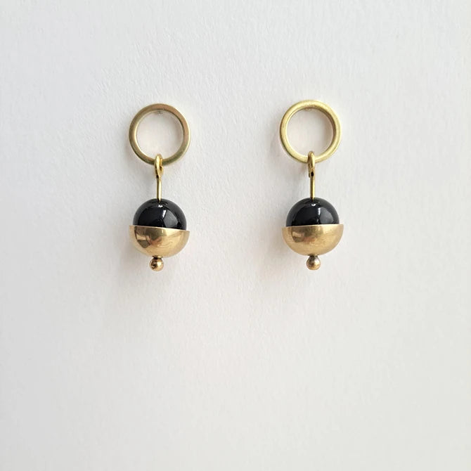 White background with a pair of Form Brass Circle, black Bead & Cup Earrings by brass+bold from Lifestory Edinburgh