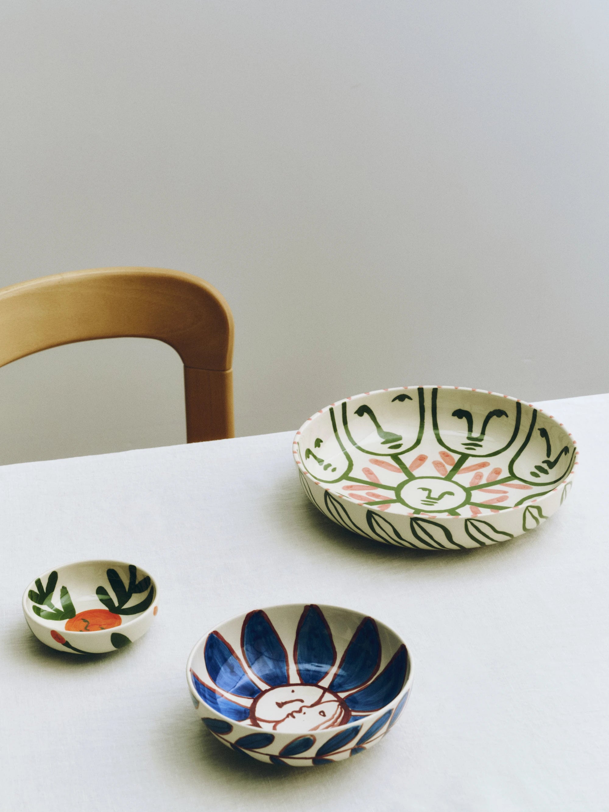 HAY x Emma Kohlmann - La Pittura collection bowls on a tableclothed table