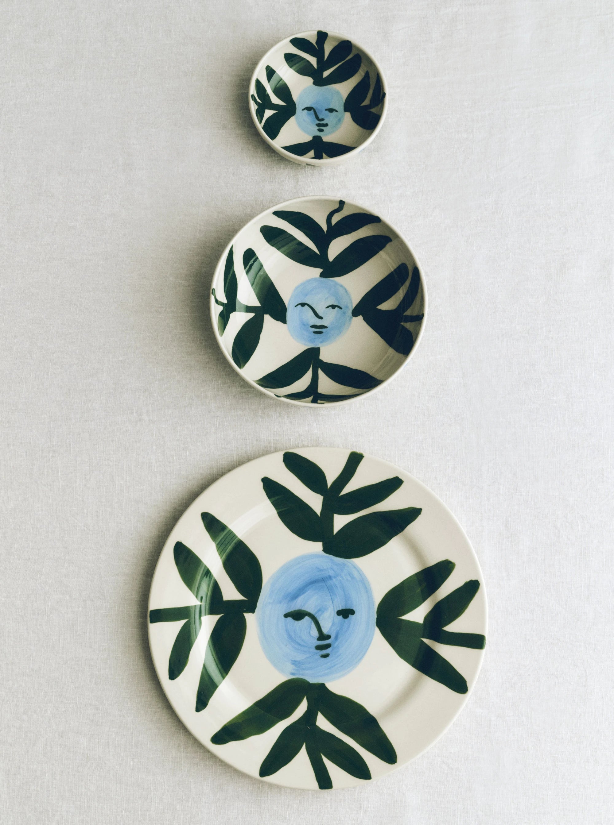 HAY x Emma Kohlmann - La Pittura Moon Face Vine plate and bowl collection on a white surface