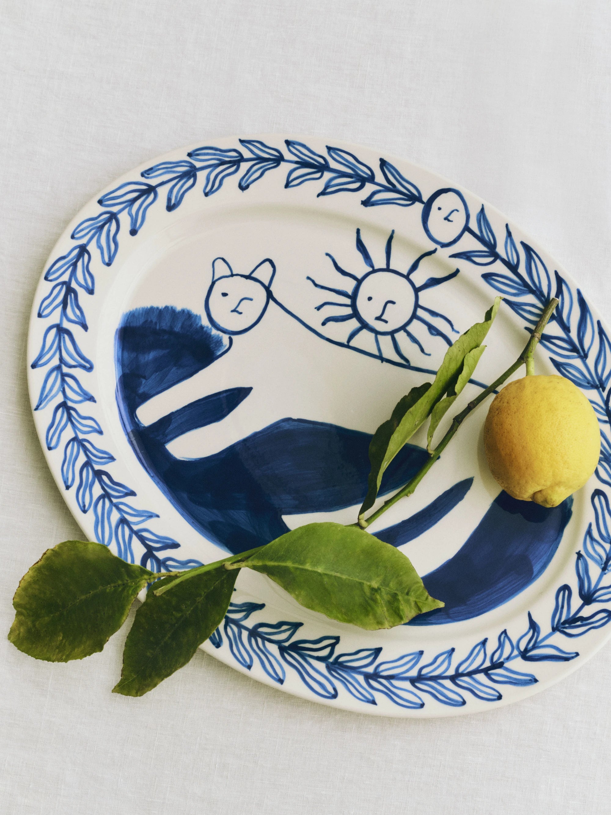 HAY x Emma Kohlmann - La Pittura Ø36.5cm Serving Platter in Chrlotte pattern with a lemon with foliage on it