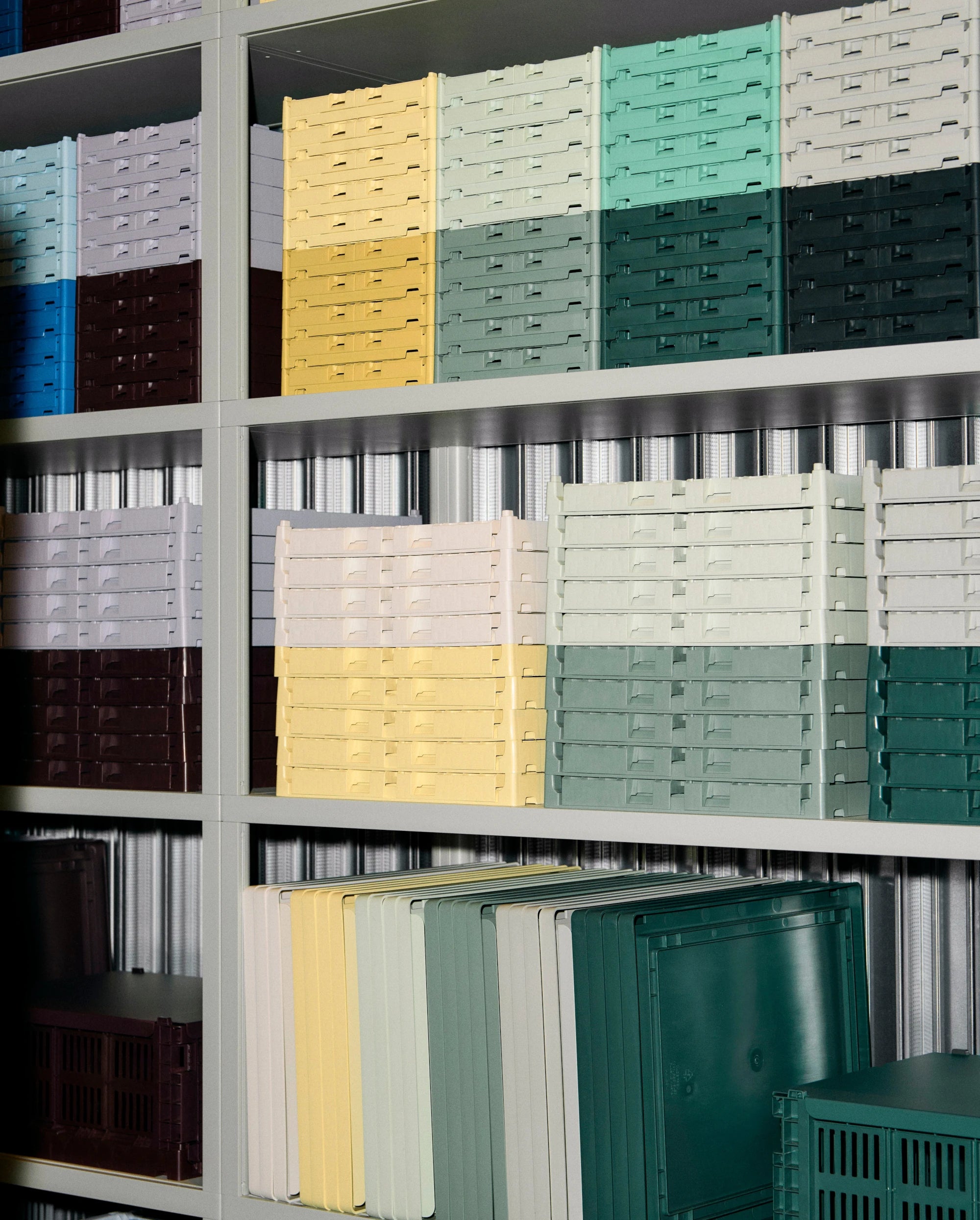 Stacked HAY colour crates in various colors on a metal shelf | Lifestory