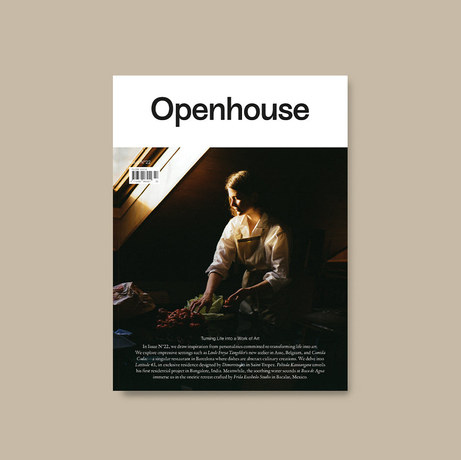 Openhouse magazine issue 22 cover image featuring a blonde woman organising fresh produce in a shadowy room lit by a single sky light