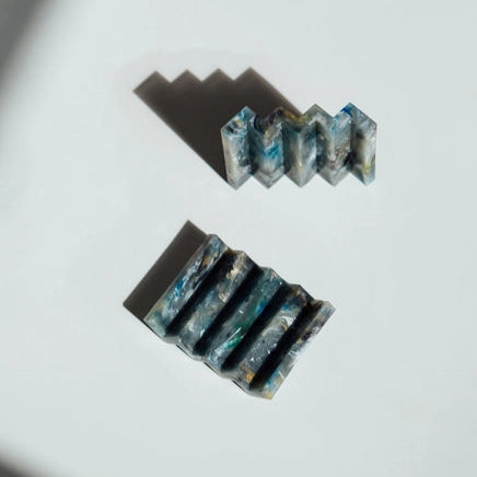 Müll Club Recycled Plastic Zip-Zag Soap Dish in Marble which is a dark mix of black, blues, creams and green with hints of gold