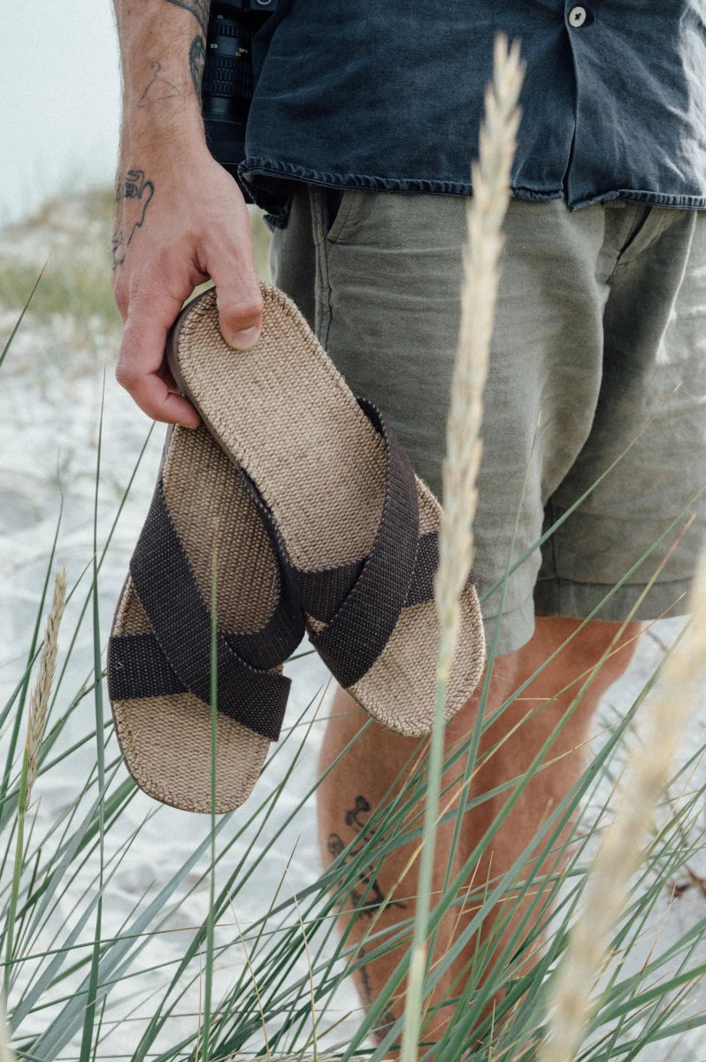 Person holding a Brown Coffee Shangies sandal with grasses in the foreground | Breathable Washable | Lifestory