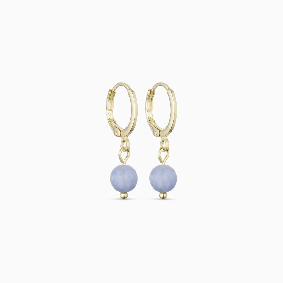 Soï Copenhagen Ava huggie hoop earrings in 18k gold with a Aquamarine stone