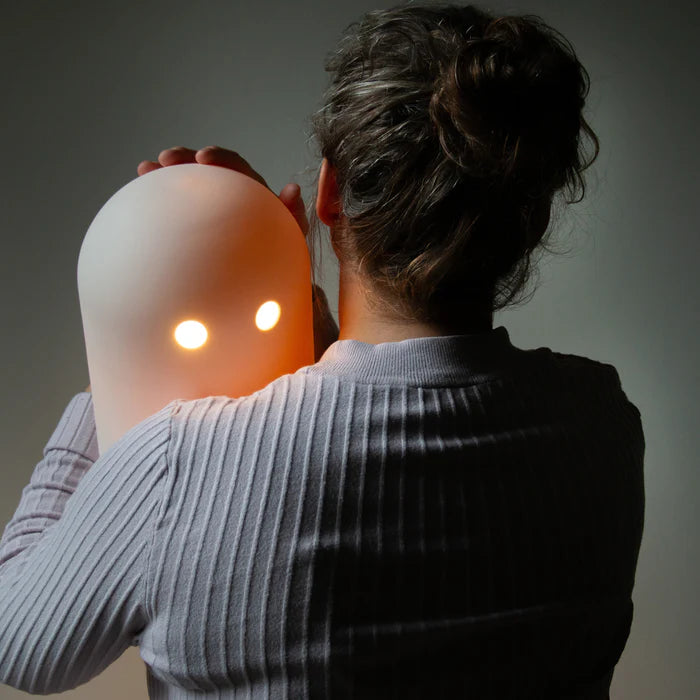 Studio Arhoj Ghost Lamp being hugged by a woman with a striped top and up do