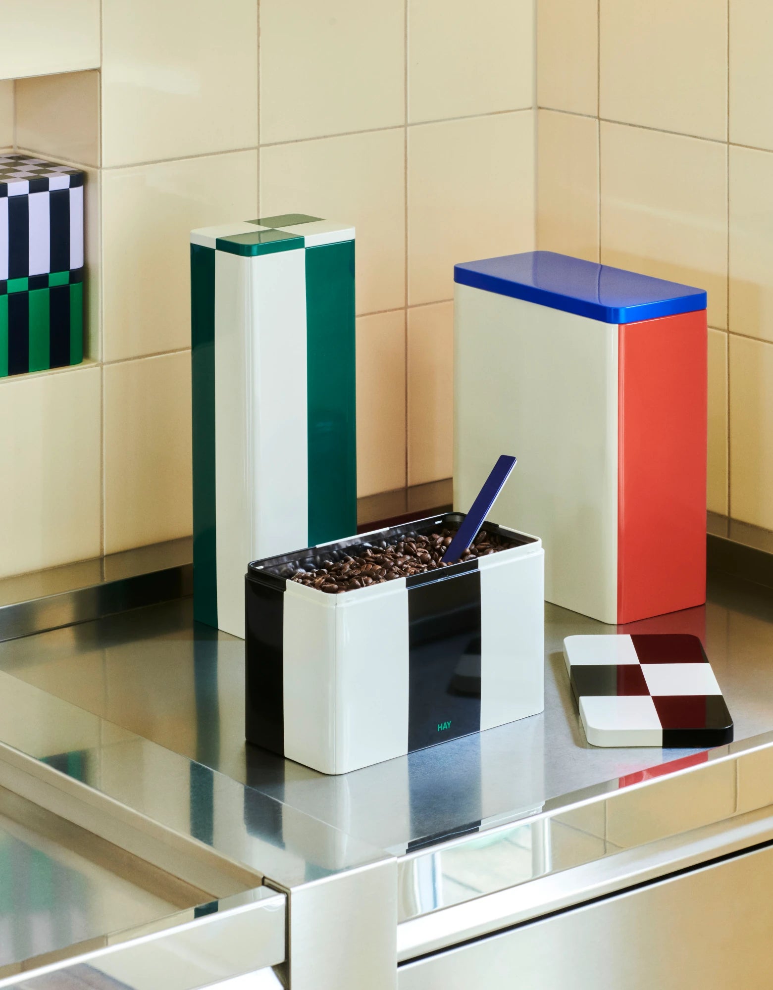 Slim Tin Container in green and off-white by HAY and other tin containers on a counter top | Lifestory