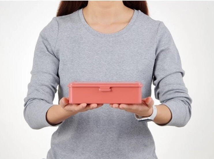 The small steel trunk tool box from Toyo Steel being held by a model for scale