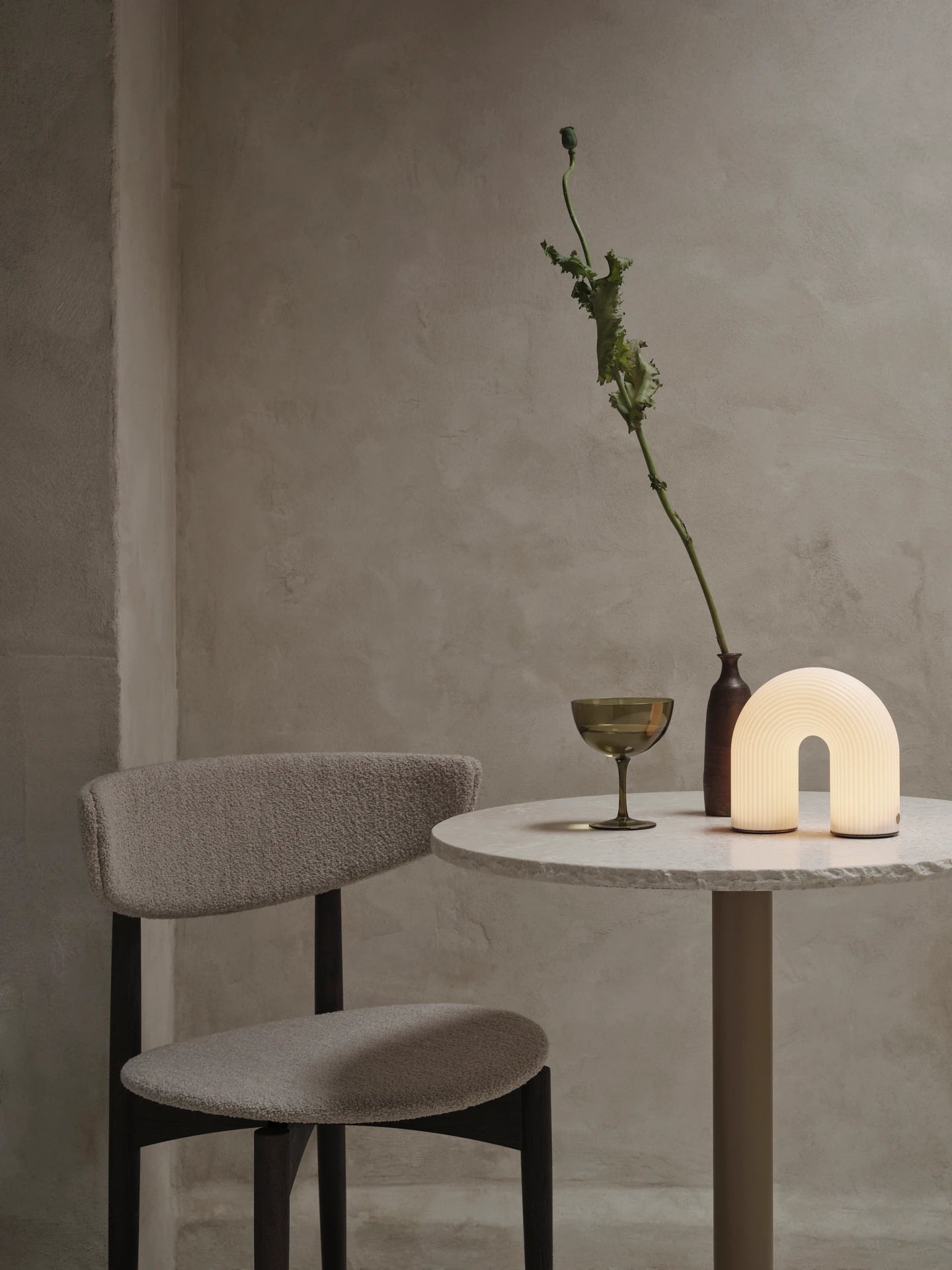 Vuelta Portable Lamp in White on a table by ferm Living | Lifestory