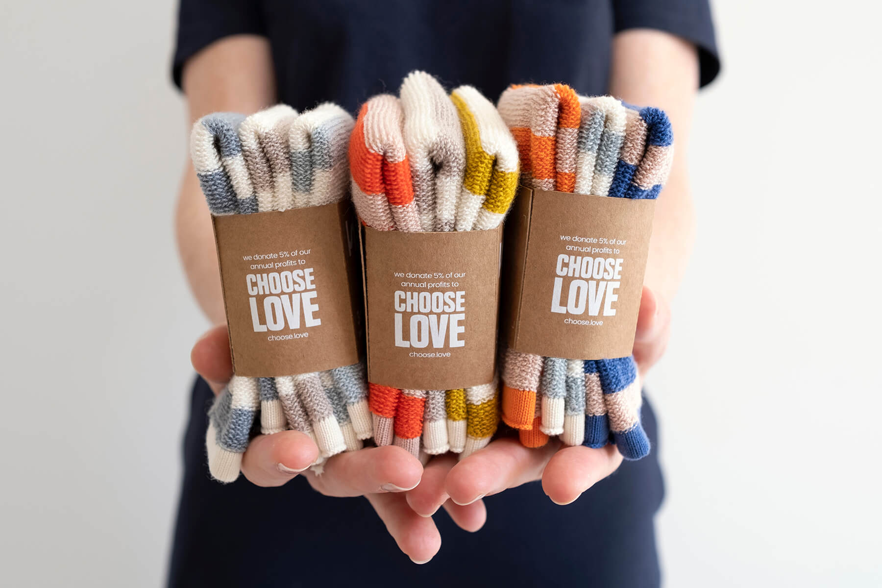 Hands holding 3 colourways of the Reusable Terry Washcloths by Sophie Home at Lifestory