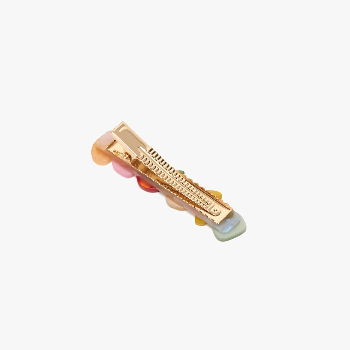 Gold hair clip with pink and green accents on a white background
