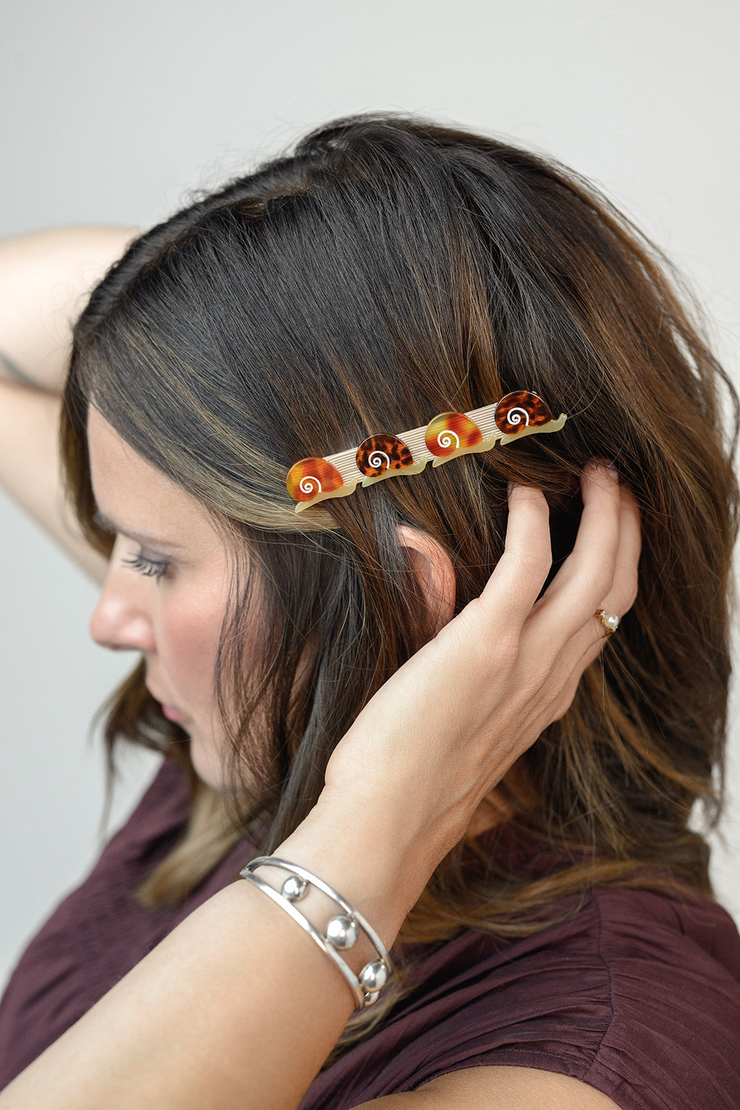 Winona Irene Escargot Snail Alligator Hair Clip being worn by a model with brown hair