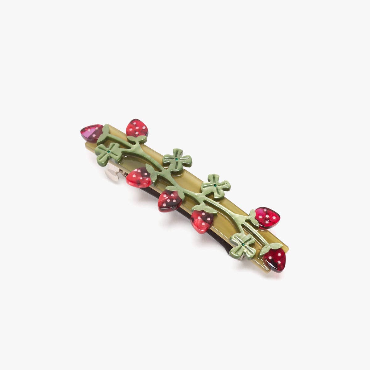 Decorative hair barrette with red berries and green leaves on a white background