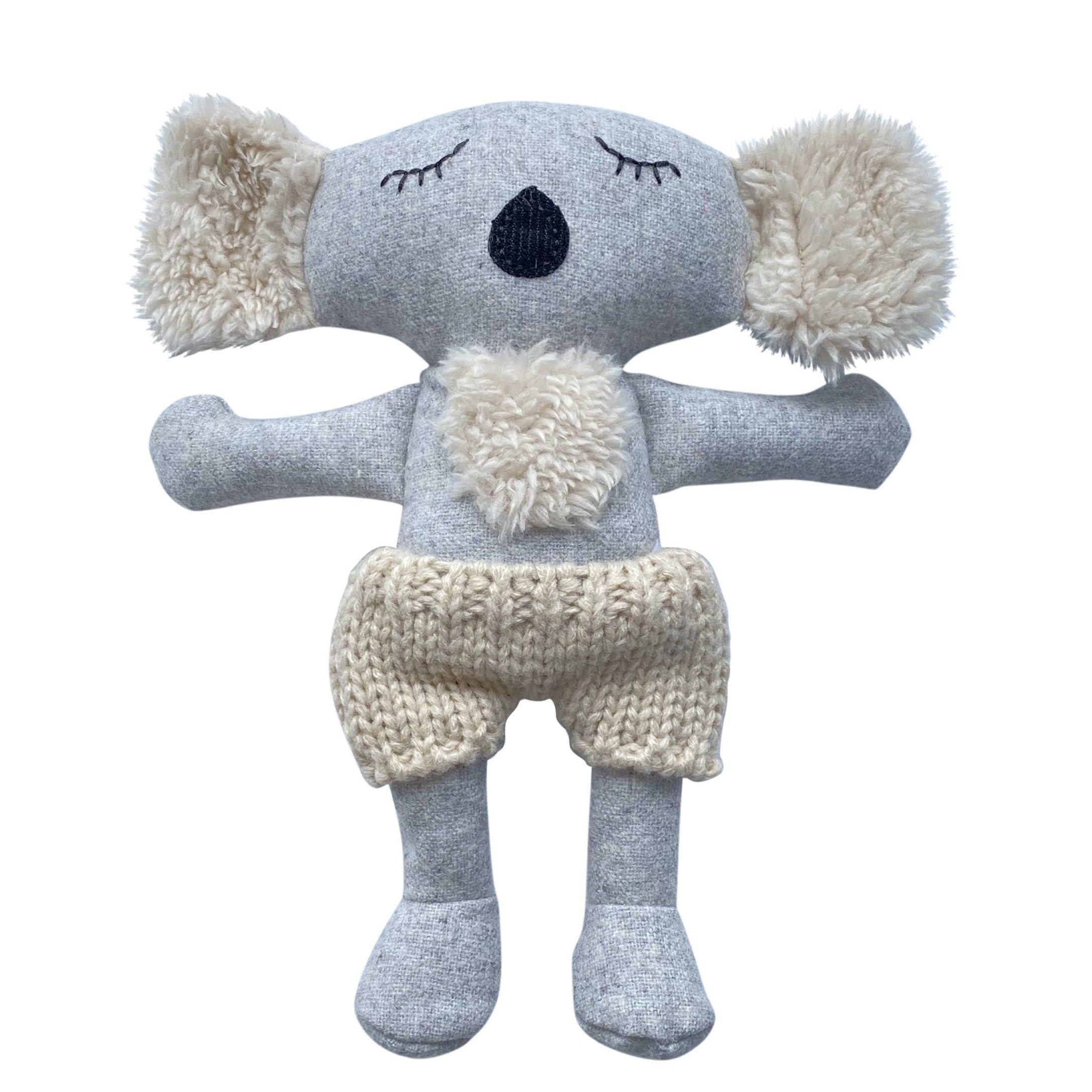 Knitted koala toy with gray body and white accents on a white background