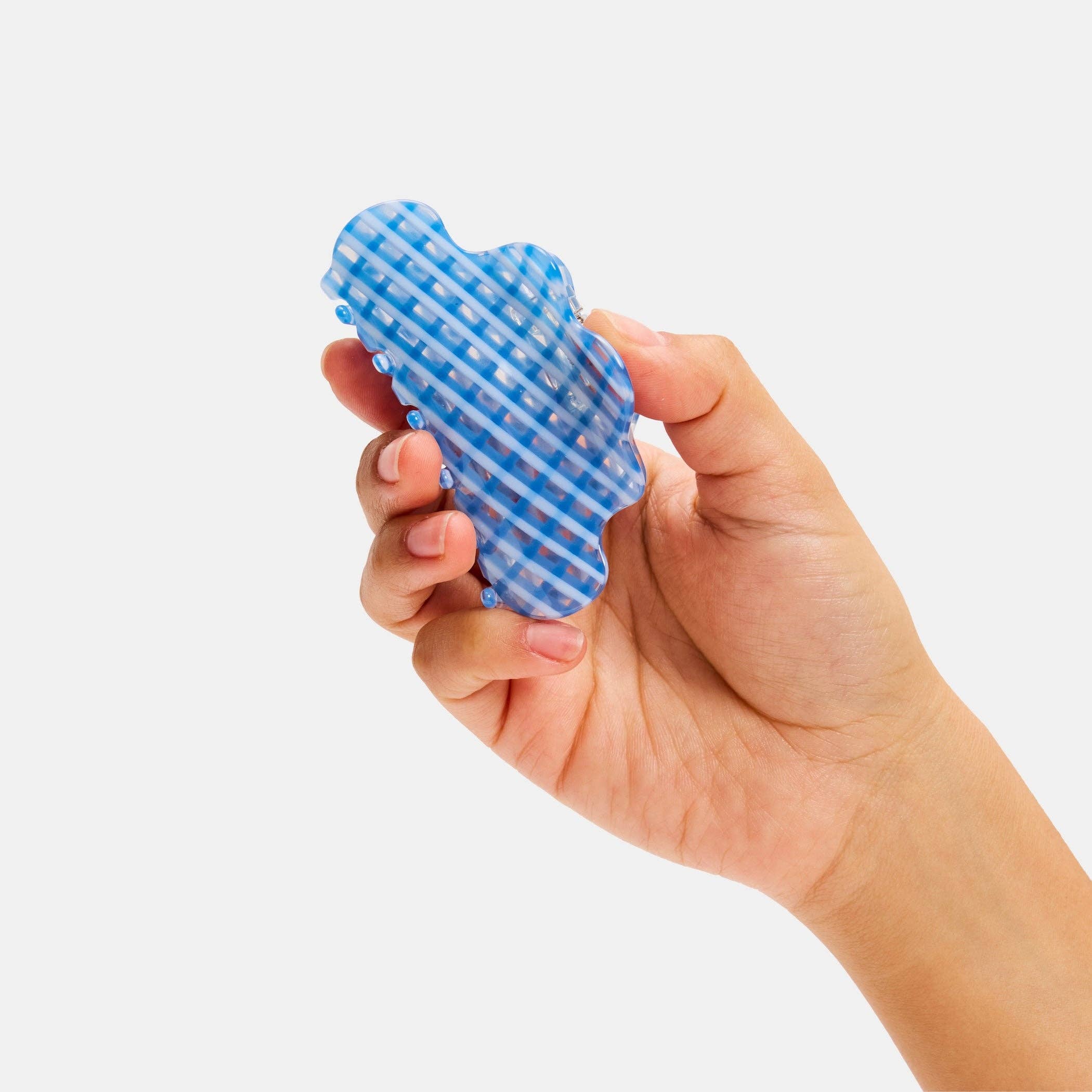 CHUNKS Baby Nimbus Hair Claw in Blue Lattice being held in a models hand
