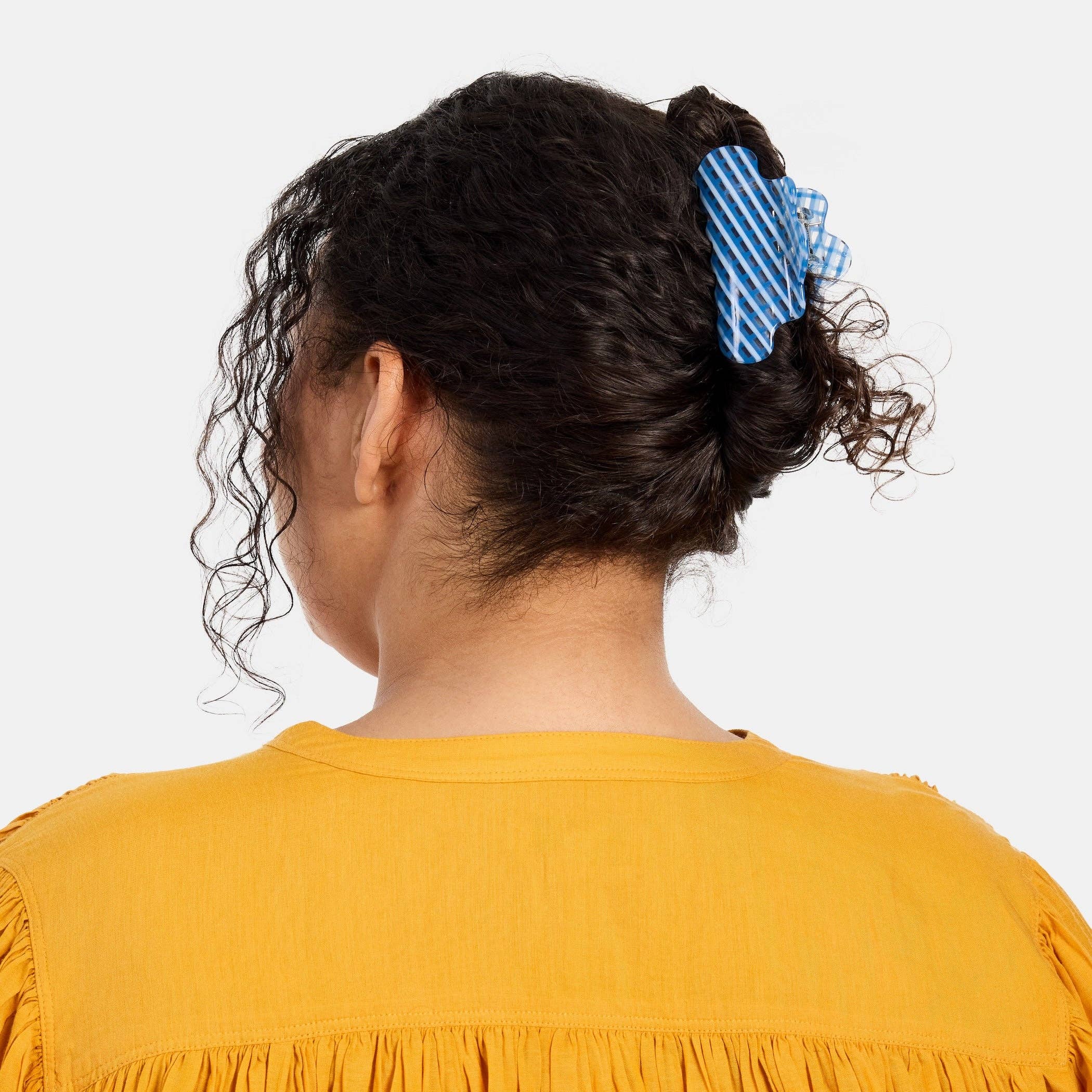 CHUNKS Baby Nimbus Hair Claw in Blue Lattice being worn by a model with dark brown wavy hair