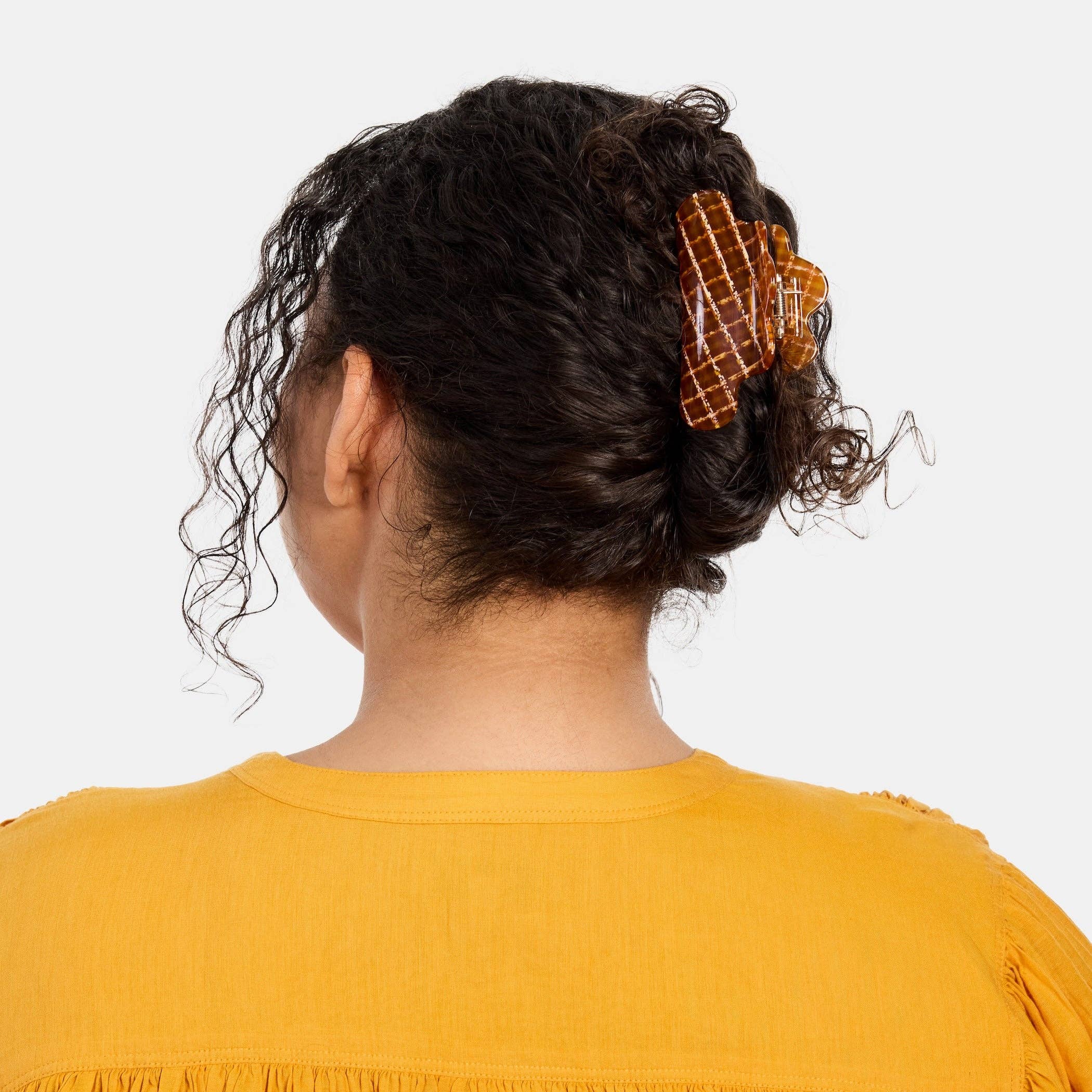 CHUNKS Baby Nimbus Hair Claw in Caramel Plaid being worn in a full up style by a model with dark brown wavy hair