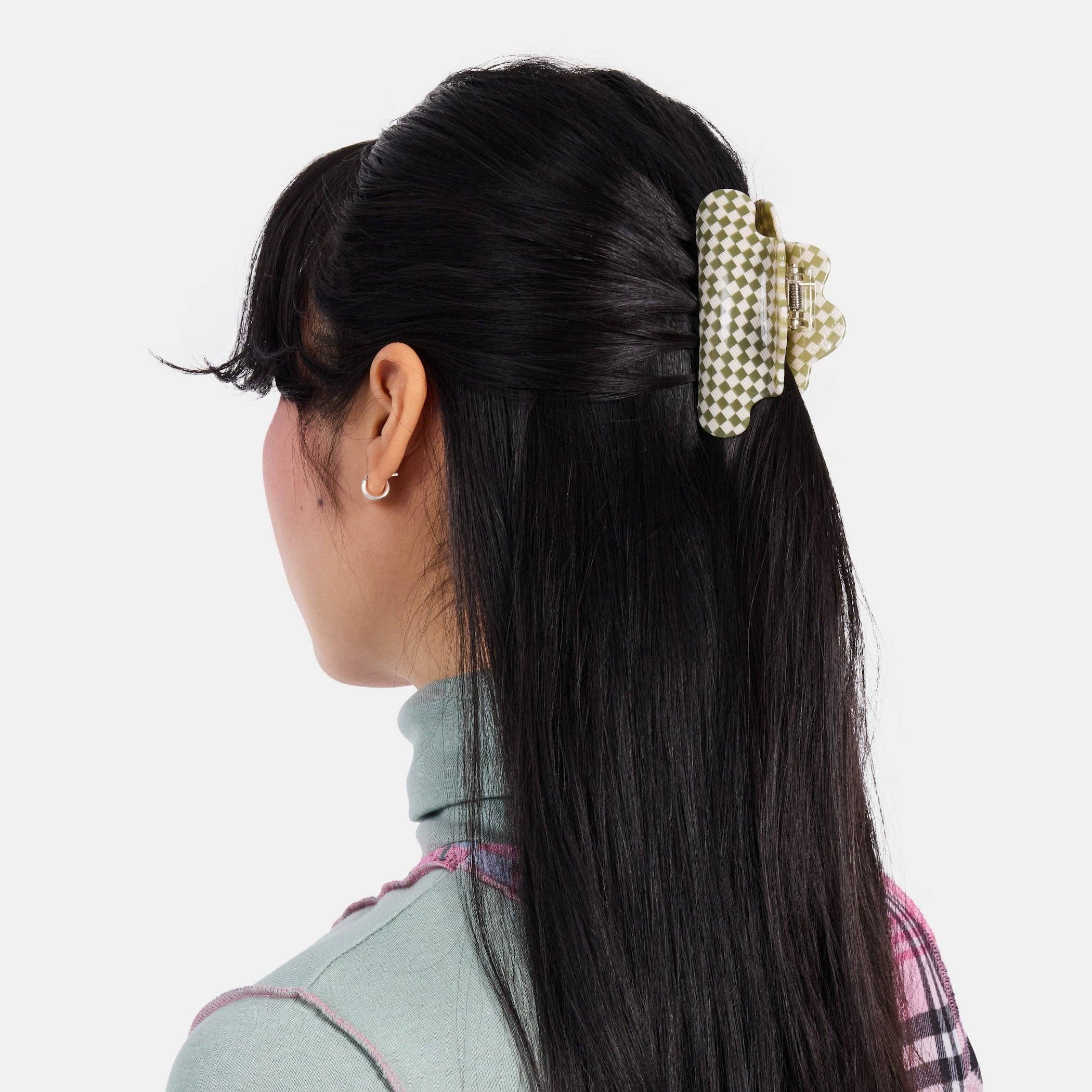 CHUNKS Baby Nimbus Hair Claw in Olive Check being worn by a model with very long black hair in a half up style