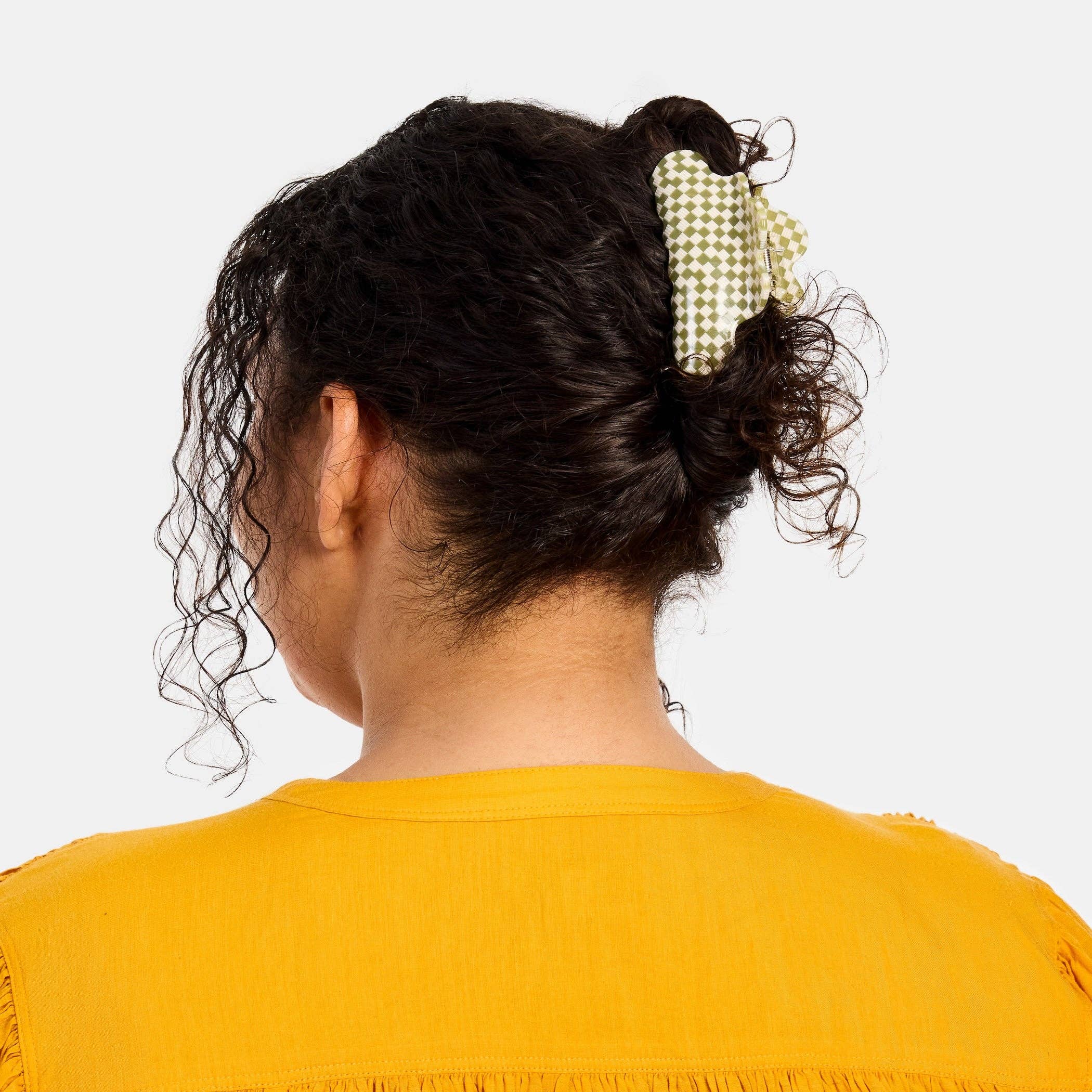 CHUNKS Baby Nimbus Hair Claw in Olive Check being worn by model with dark brown wavy hair