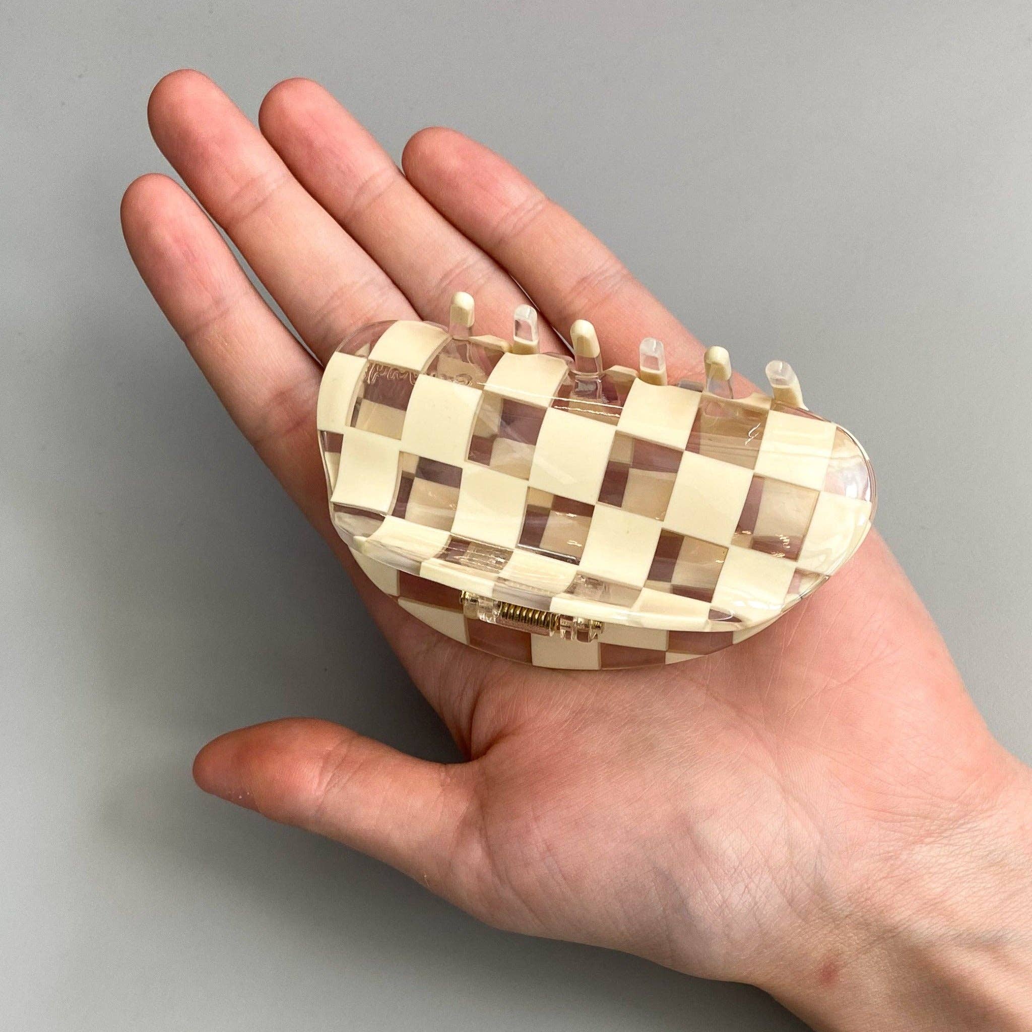 CHUNKS Checker Hair Claw in Clear being held by a models hand