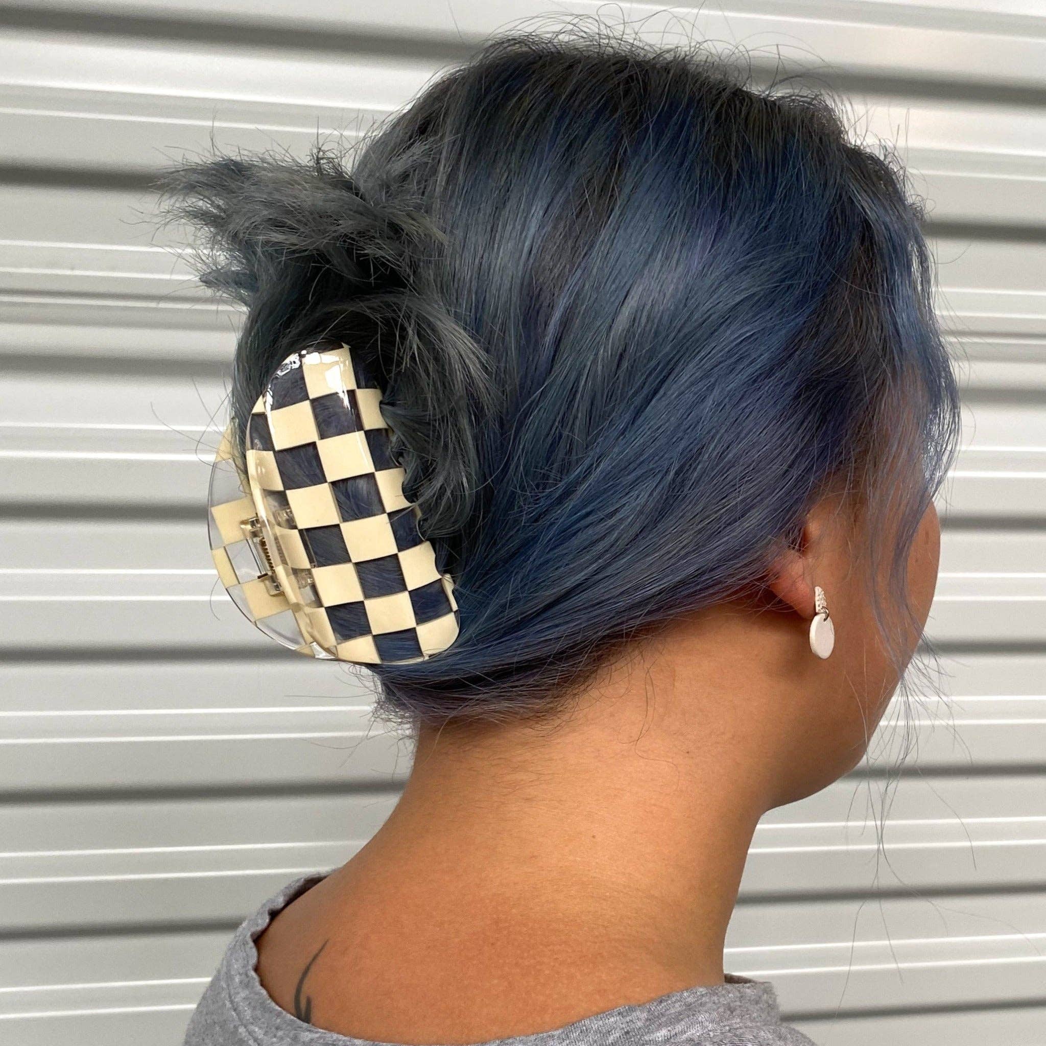 CHUNKS Checker Hair Claw in Clear being worn by a model with grey blue hair in an up do