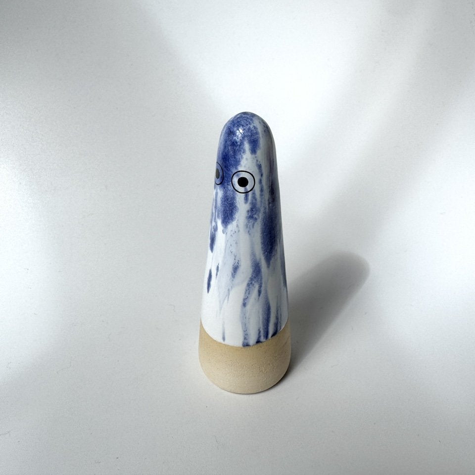 Mikey Studio Arhoj ghost with a blue and white marbled pattern, featuring two black and white eyes, with a white background.