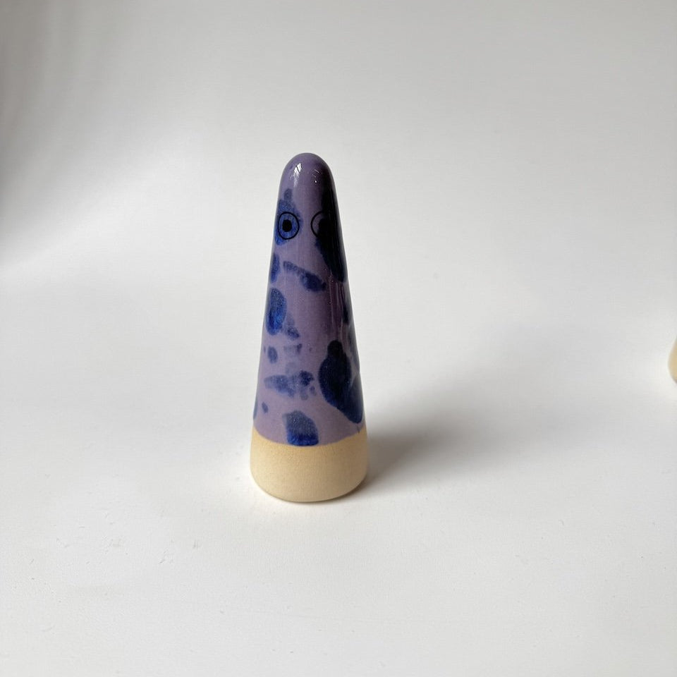 Caleb Studio Arhoj ghost with a purple and blue marbled pattern on the upper half and a beige base, photographed against a plain light grey background.
