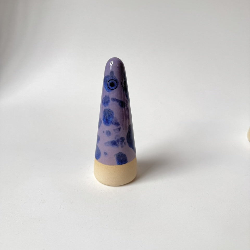 Caleb Studio Arhoj ghost with a purple and blue marbled pattern on the upper half and a beige base, photographed against a plain light grey background.