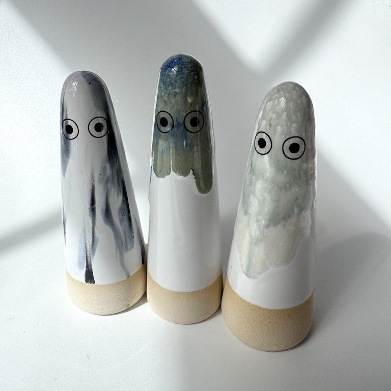 Three Studio Arhoj ghosts arranged on a white surface with soft shadows.