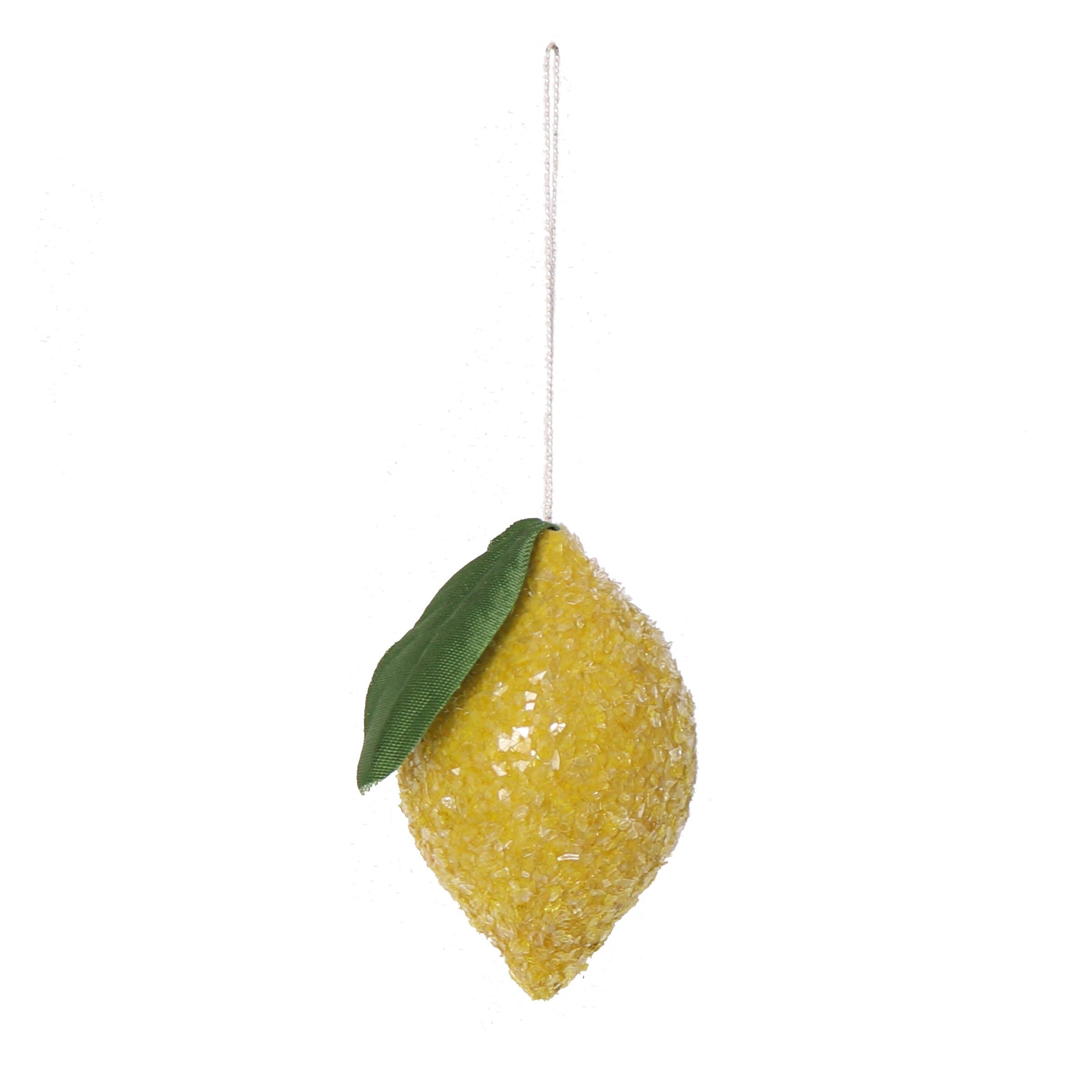 Decorative lemon ornament with a green leaf on a white background