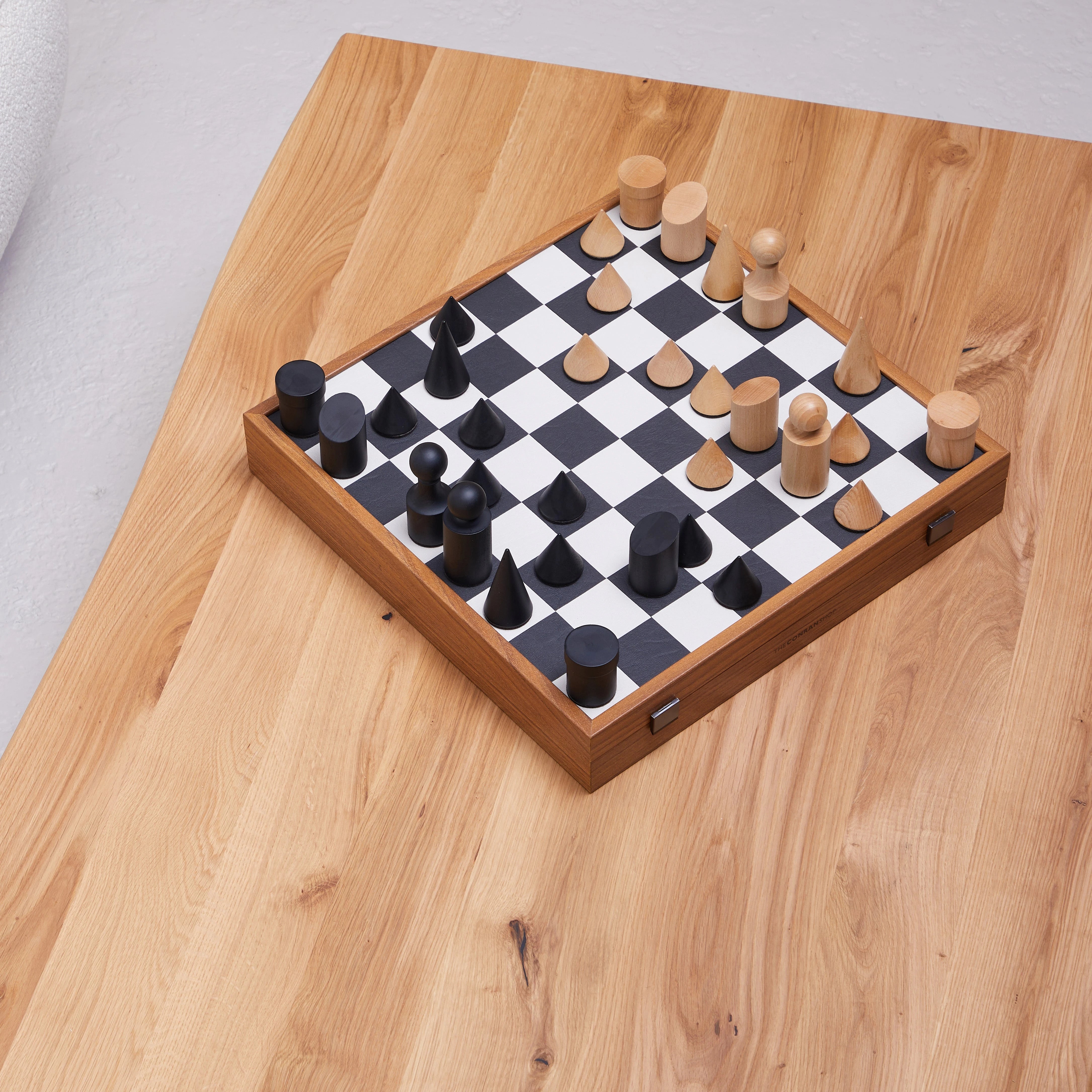 Milos Wooden Chess Set by The Conran Shop in black and white on a wooden table
