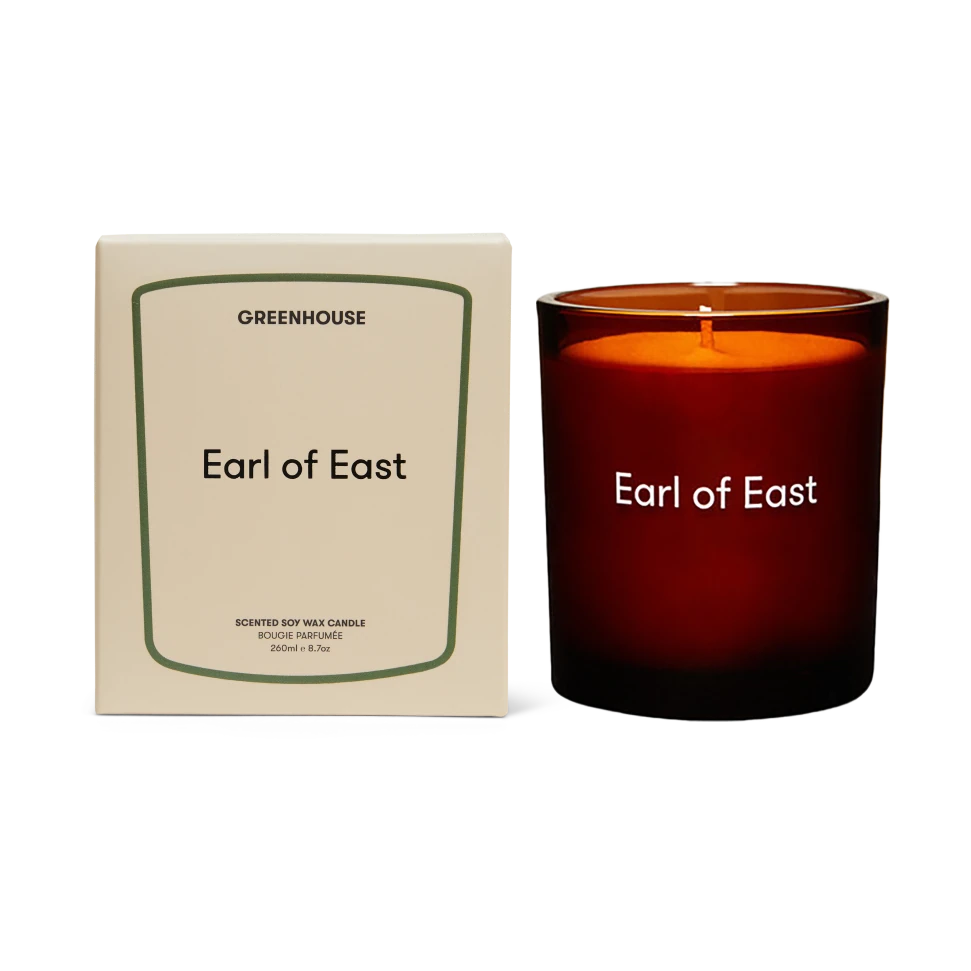 Candle labeled 'Earl of East' with packaging on a white background