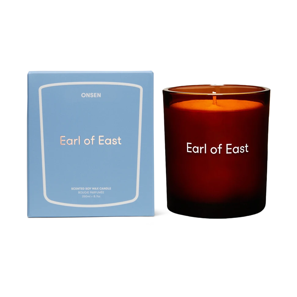 Candle labeled 'Earl of East' with a matching blue box on a white background