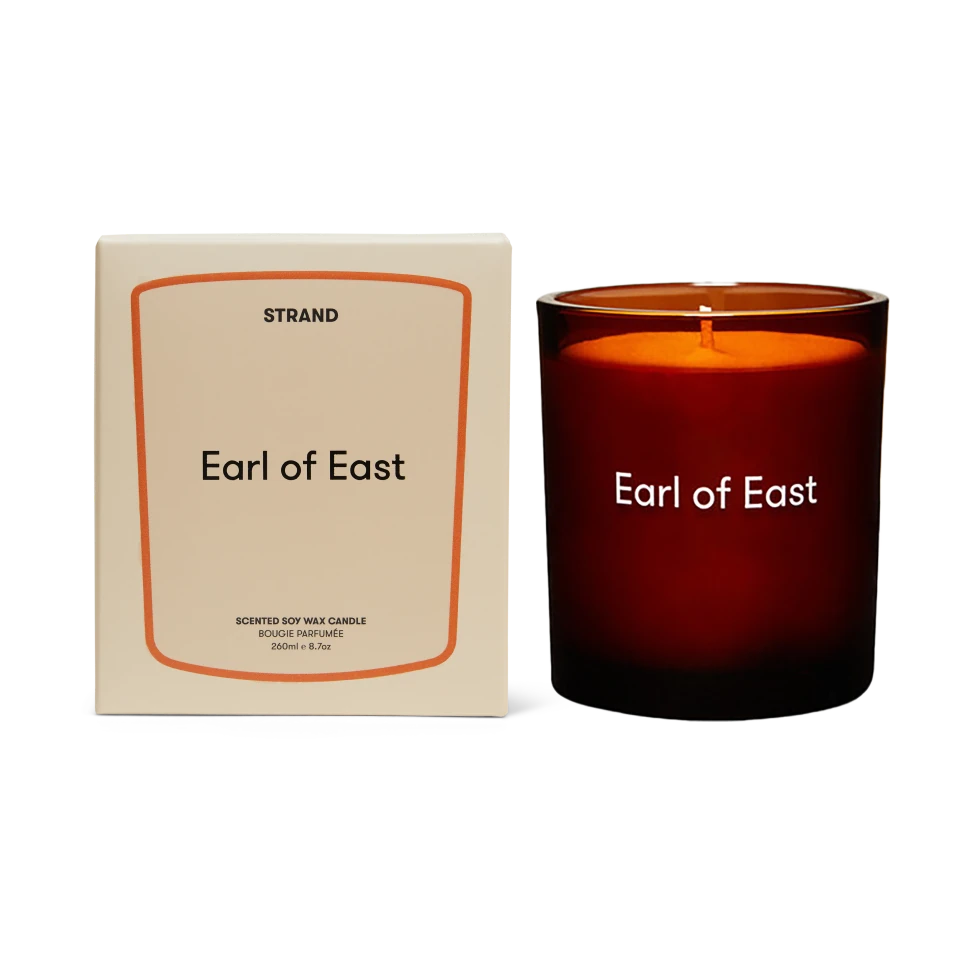 Candle labeled 'Earl of East' with packaging on a white background