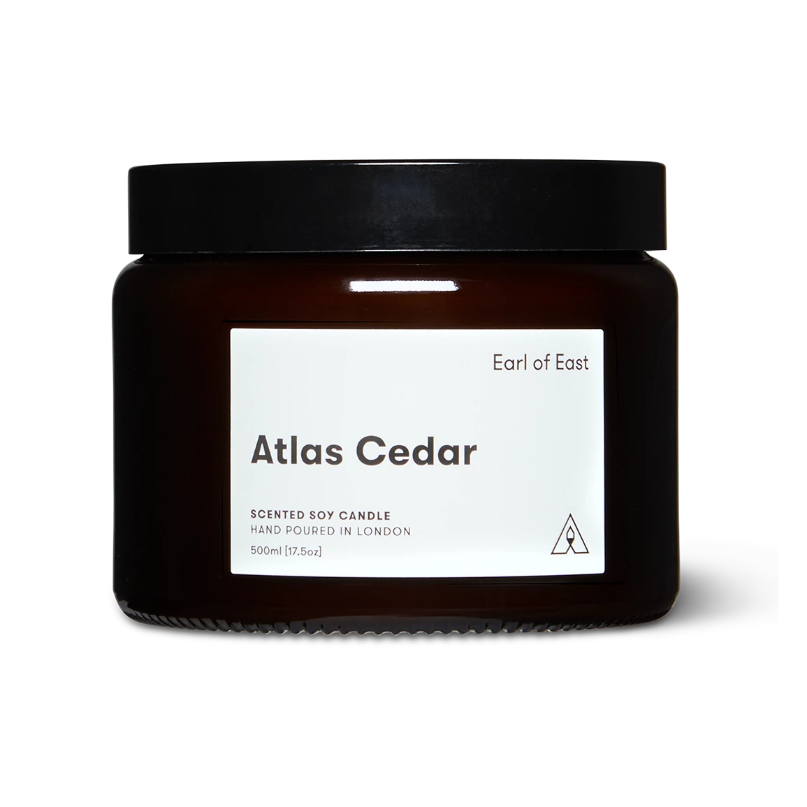 Scented candle jar labeled 'Atlas Cedar' by 'Earl of East' on a white background