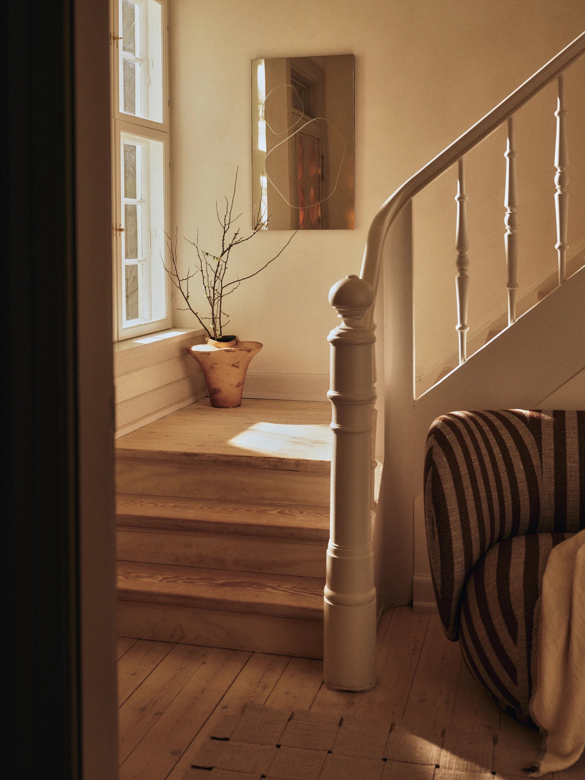 Staircase with wooden steps and white railings in a home interior.