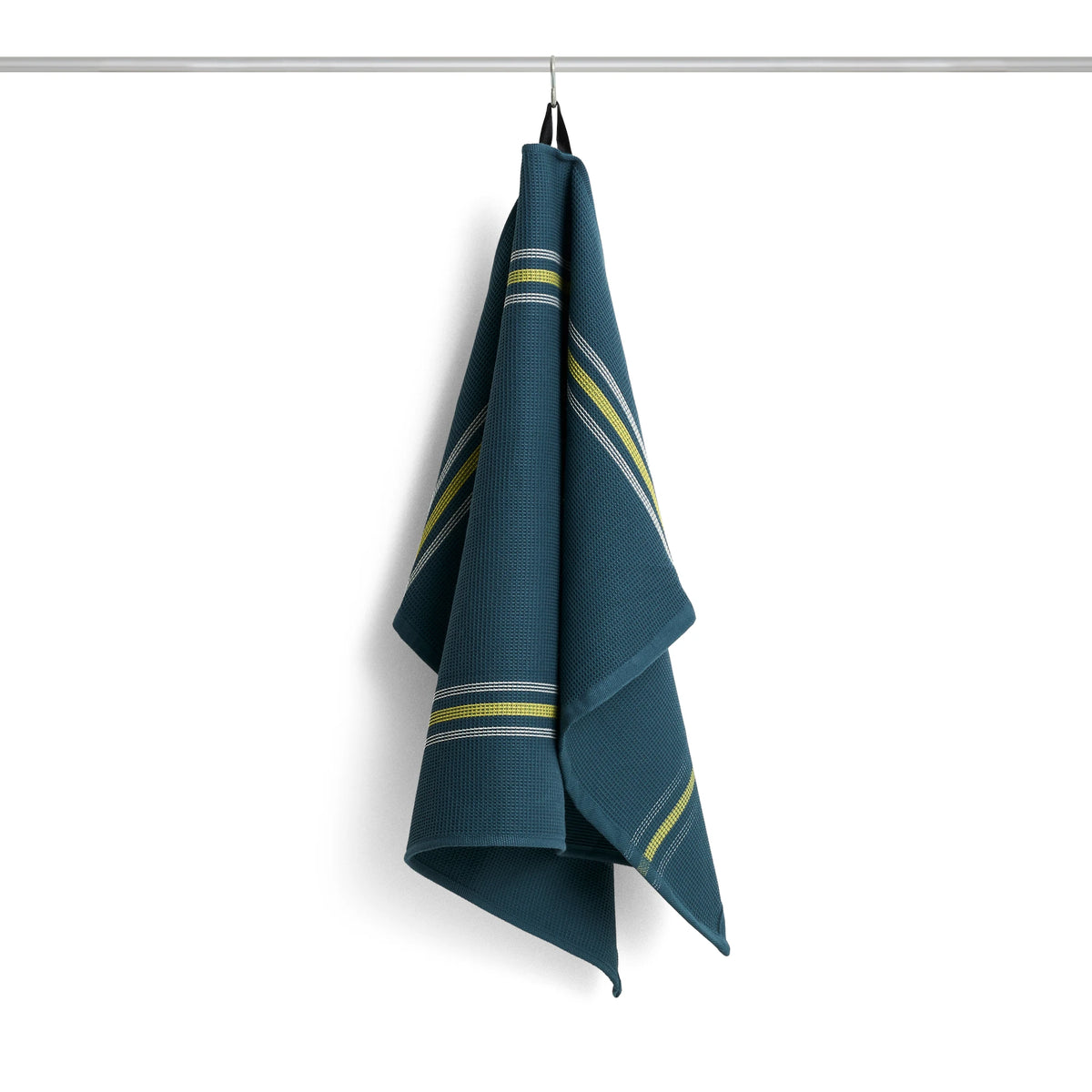 A dark teal HAY Canteen kitchen towel with diagonal yellow and white stripes, hanging from a metal rod against a plain white background.