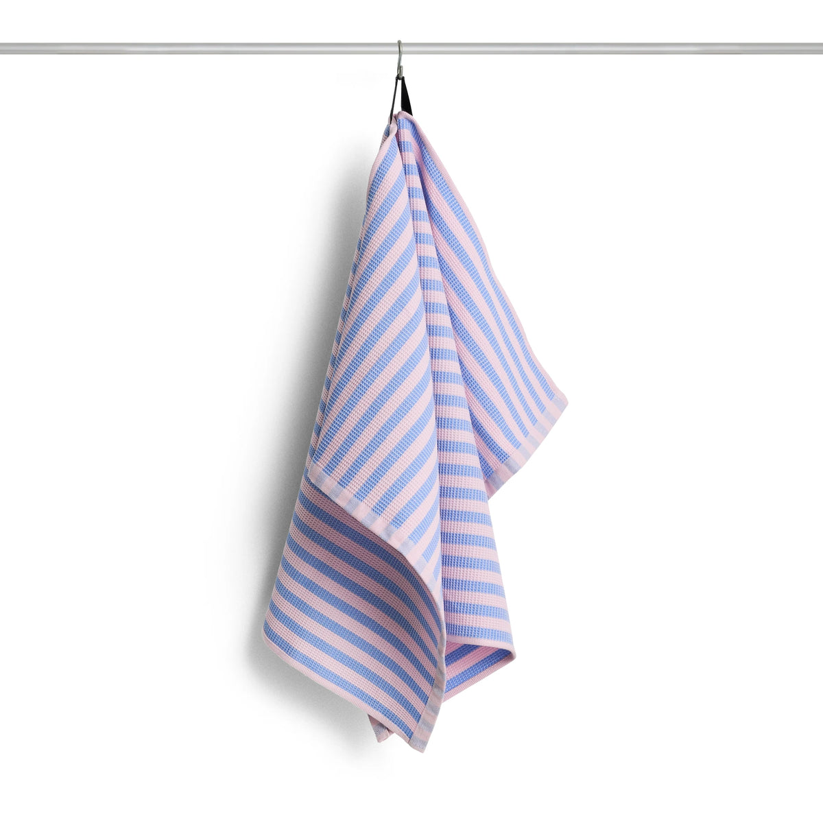 A striped HAY Canteen kitchen towel with alternating sky blue and pink horizontal stripes, hanging from a black hook on a metal rod against a white background.