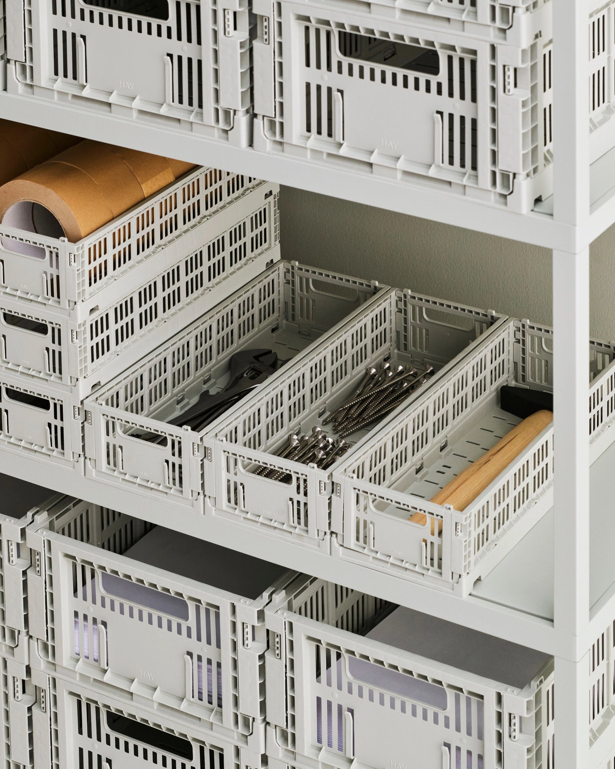Stack of HAY colour storage crates with items inside on a white shelf | Lifestory