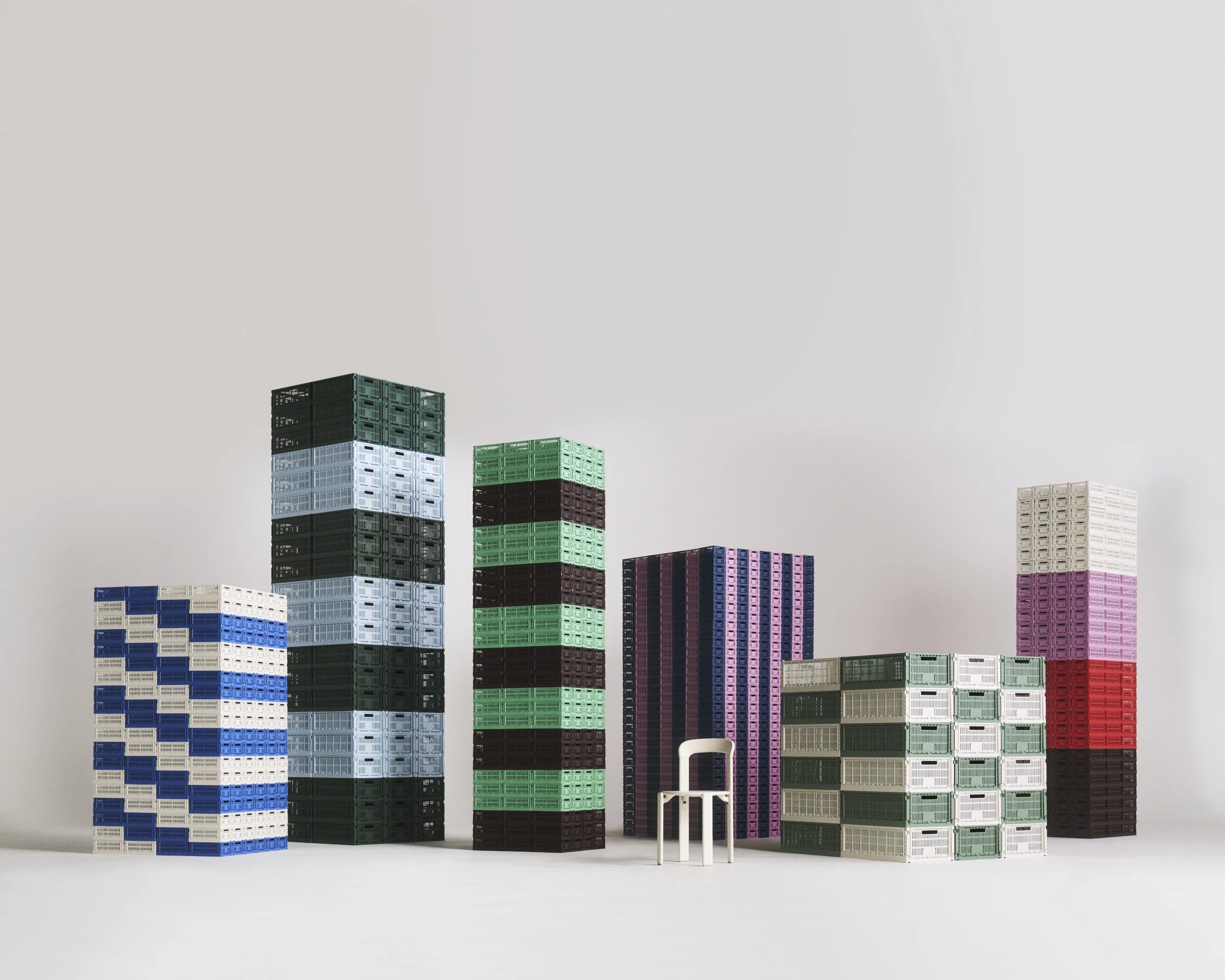 Stacks of colorful geometric-patterned HAY colour crates on a white background | Lifestory