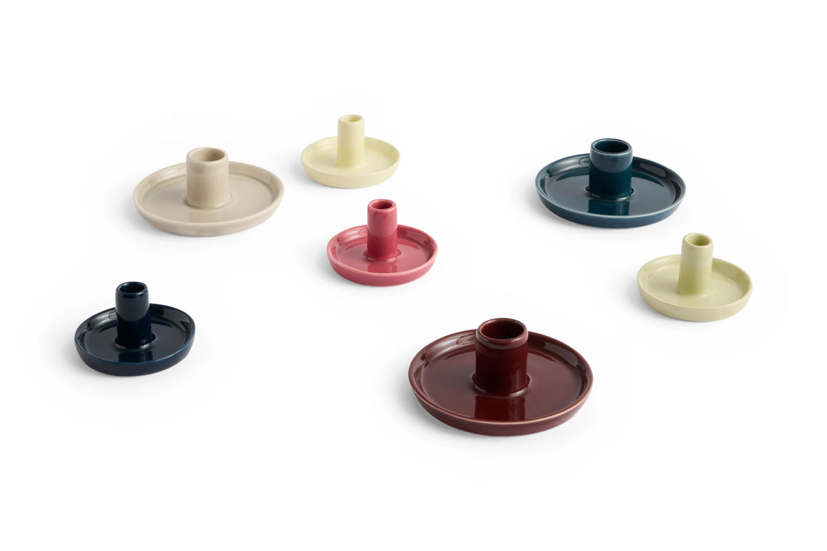 Set of colorful ceramic HAY disc candle holders on a white background
