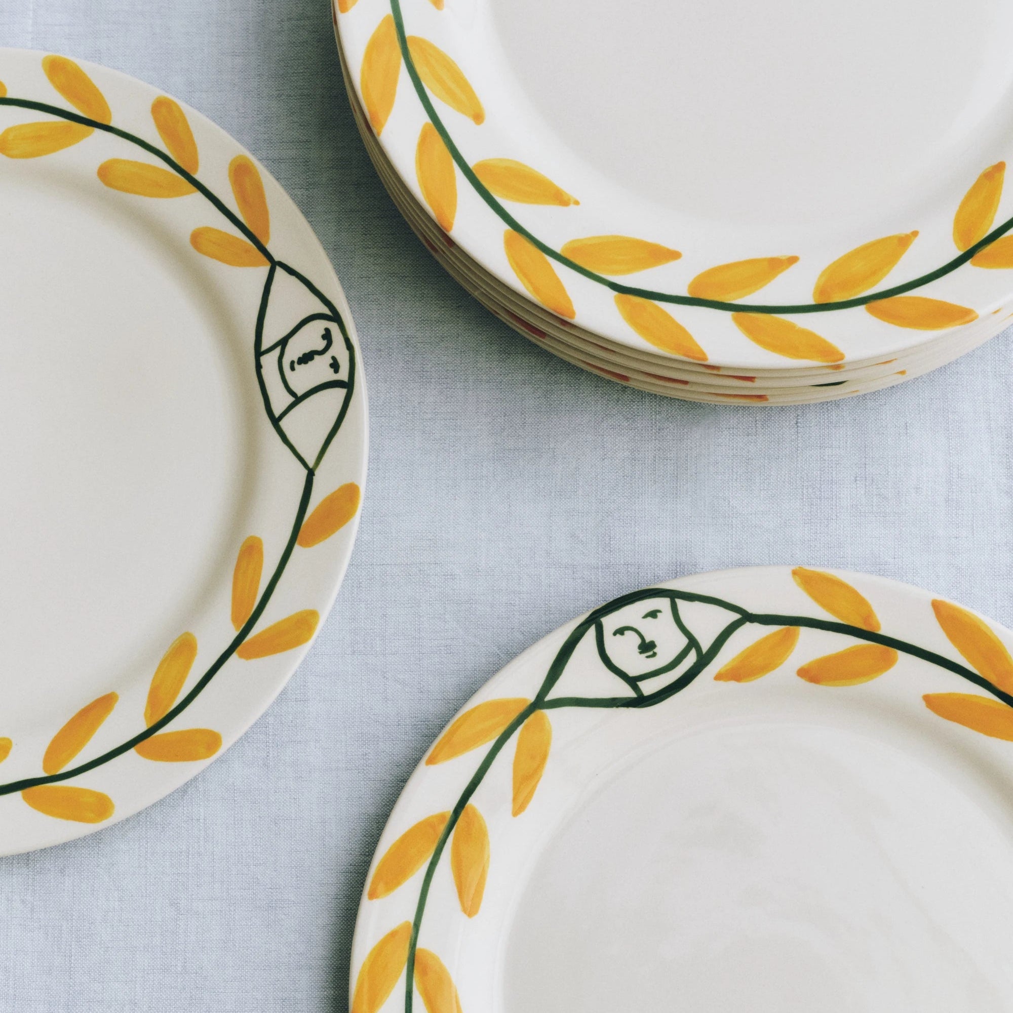 HAY x La Pittura Golden Leaf plates together on a grey table cloth