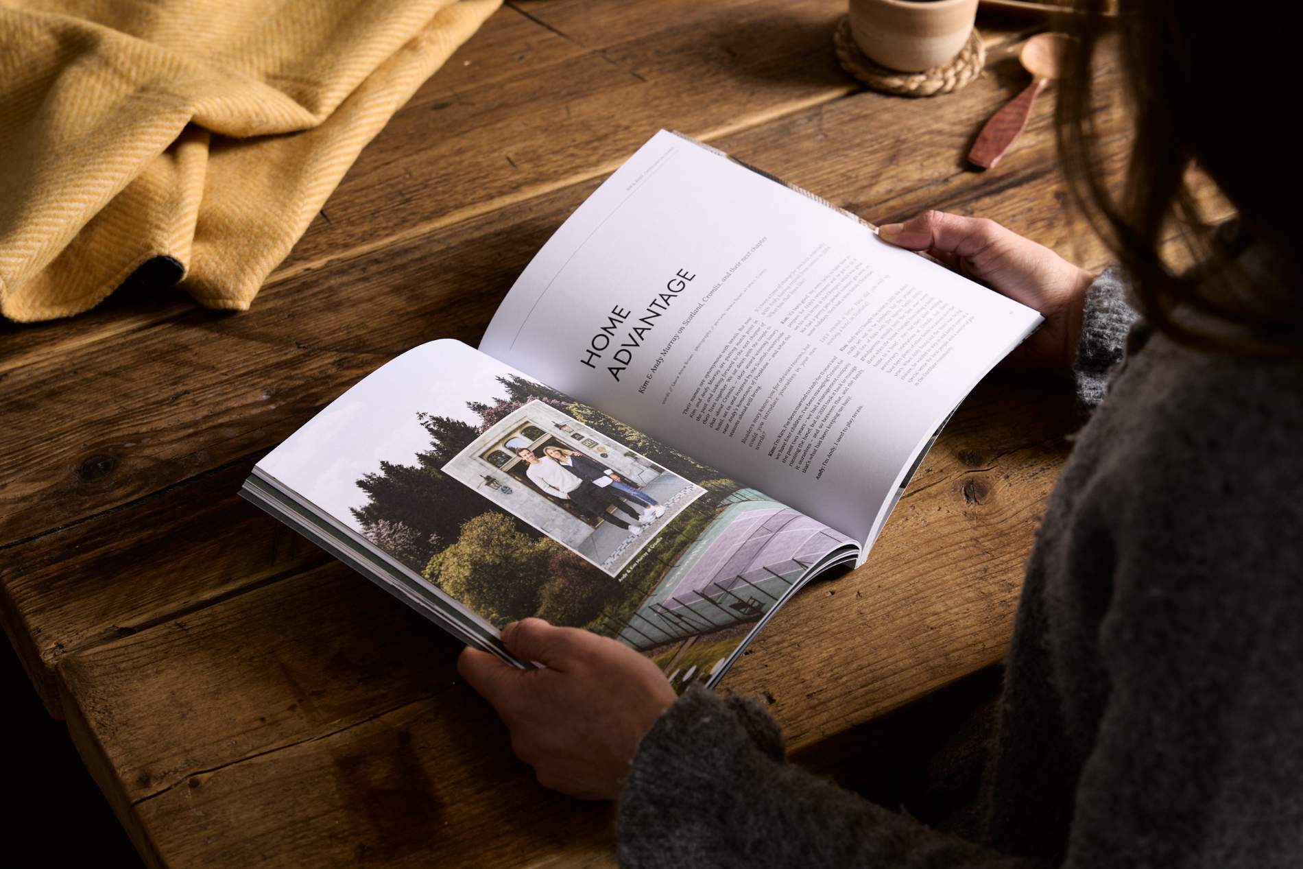 Hidden Scotland Magazine Issue 10 held open in hands on a wooden table at Lifestory Store